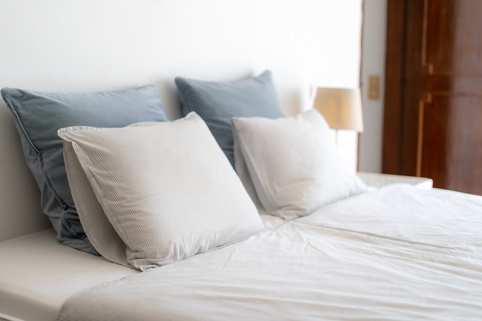 A calm bedroom with a soft bed and natural morning light