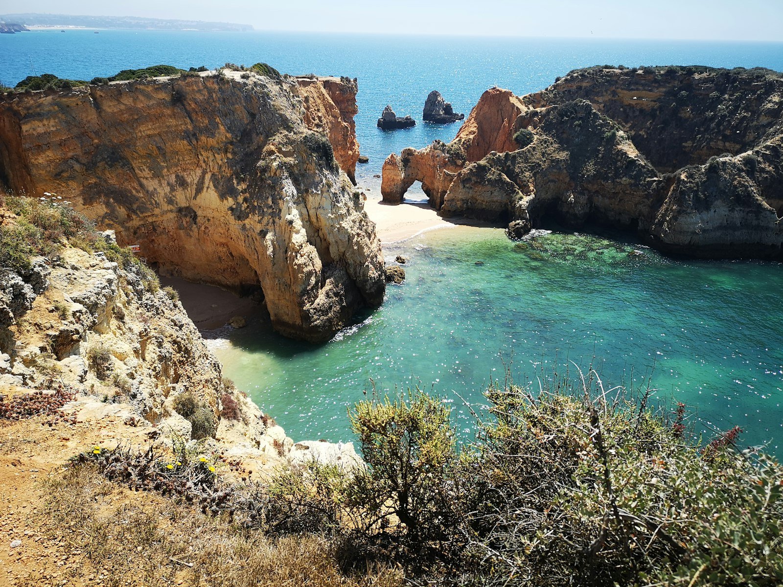 The golden cliffs and clear water of the Algarve coast near Lagos