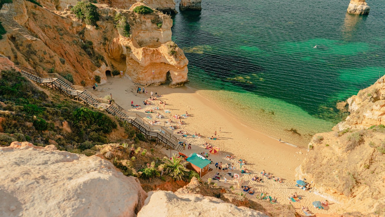 The golden cliffs and turquoise water of a Lagos cove on the Algarve coast, a short walk from the old town
